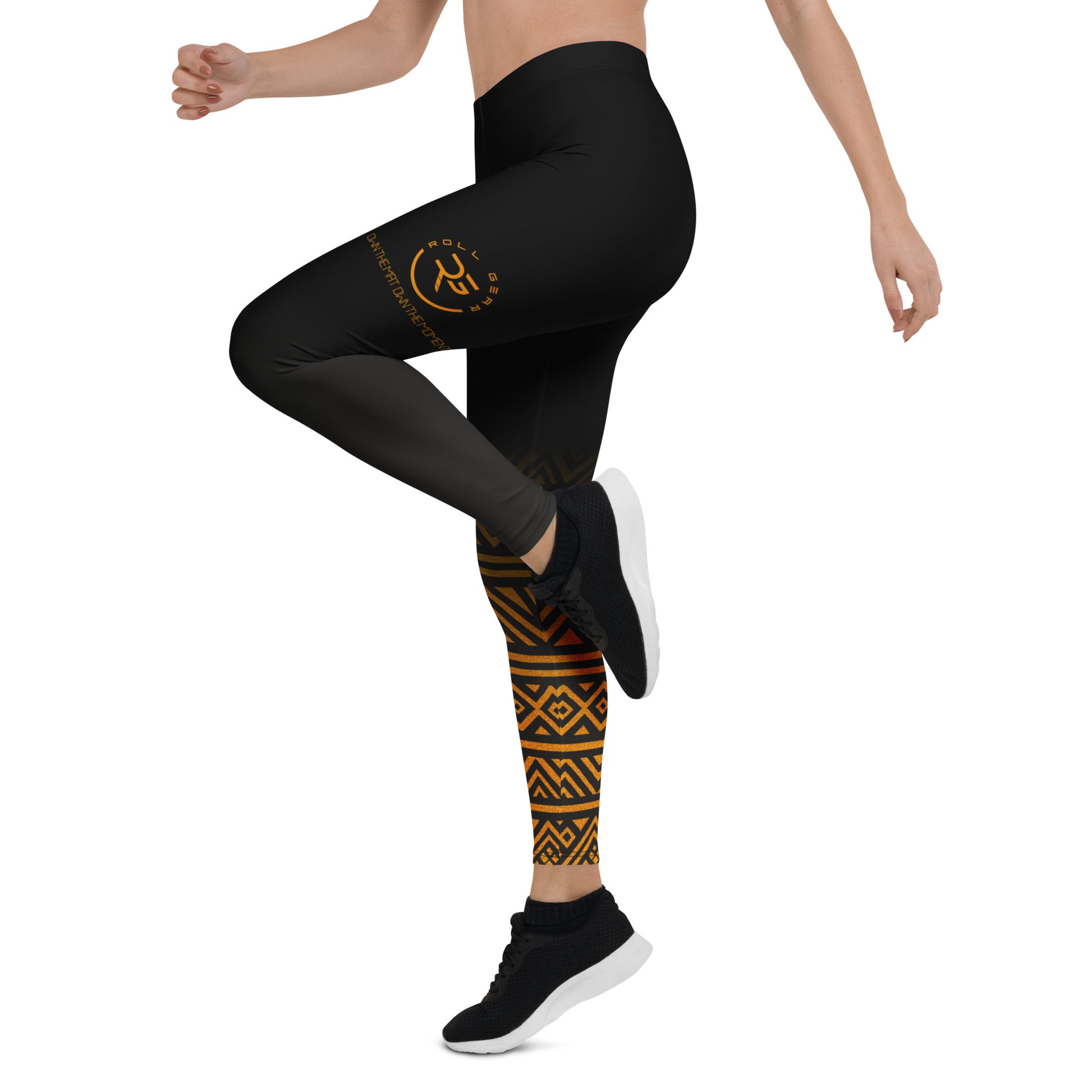 Person wearing black leggings with a logo and patterned socks on a white background