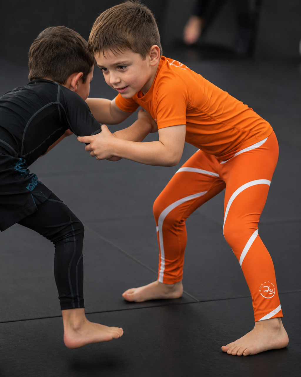 Orange Swirl Spats – Orange/White – Kids | Roll Gear