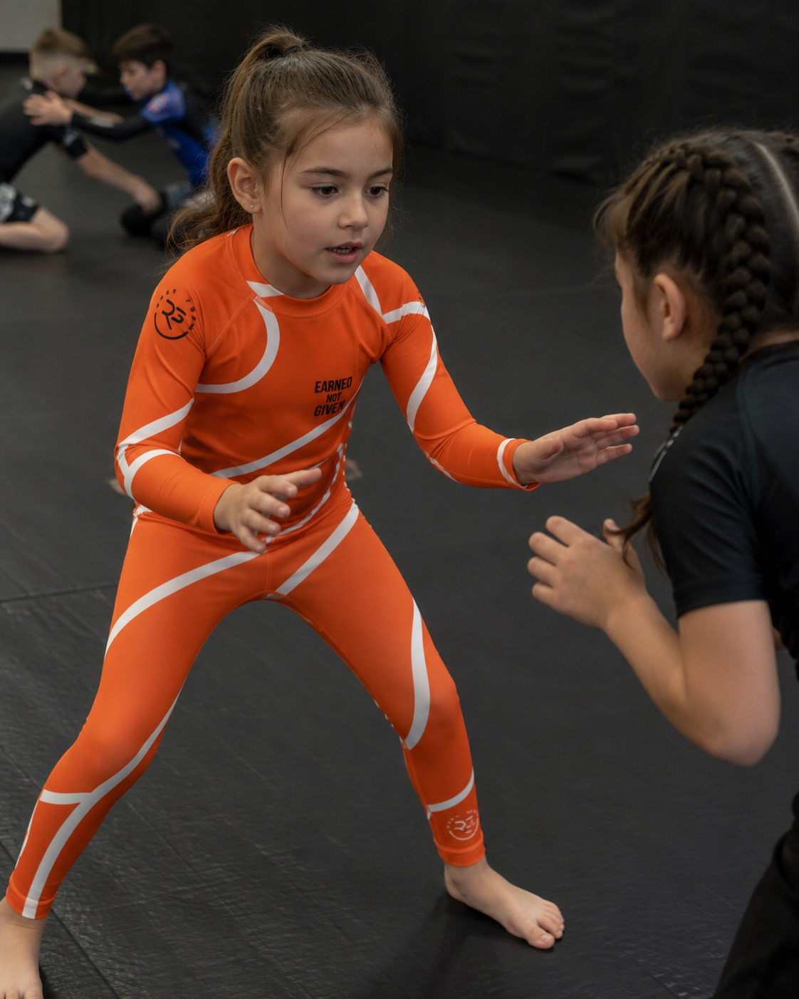 Orange Swirl Spats – Orange/White – Kids | Roll Gear