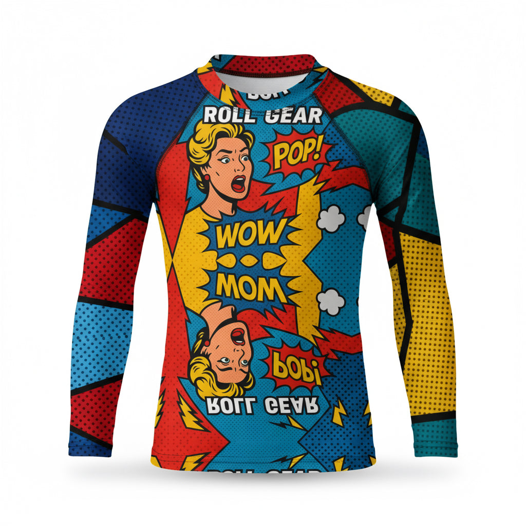 Kids long-sleeve rash guard with vibrant comic pop art design featuring bold red, blue, yellow, and teal color blocks, comic-style graphics, and text bubbles saying POP! and WOW MOM. Unisex limited edition training gear for boys and girls in BJJ, wrestling, and MMA.”