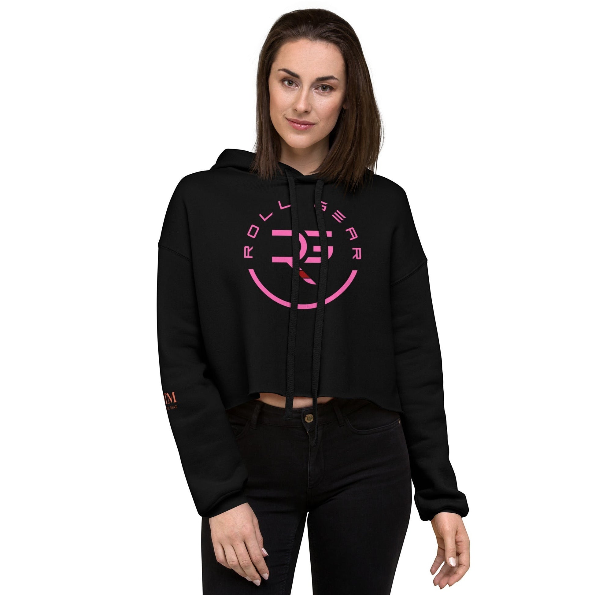 Roll Gear women's black cropped hoodie with pink logo on chest and sleeve. Model is wearing black jeans.