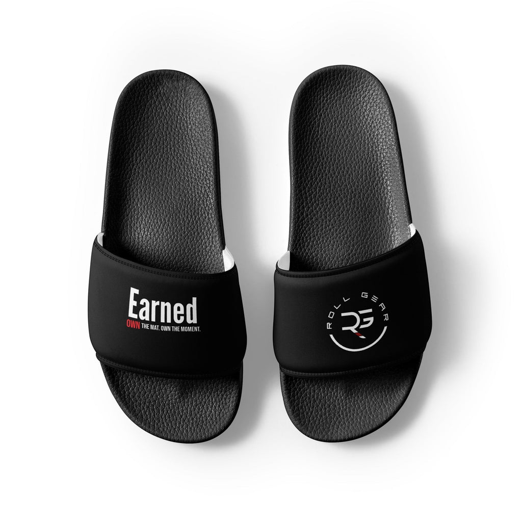 Roll Gear black men's slides with cushioned footbed and secure strap featuring 'Earned' graphic and logo.