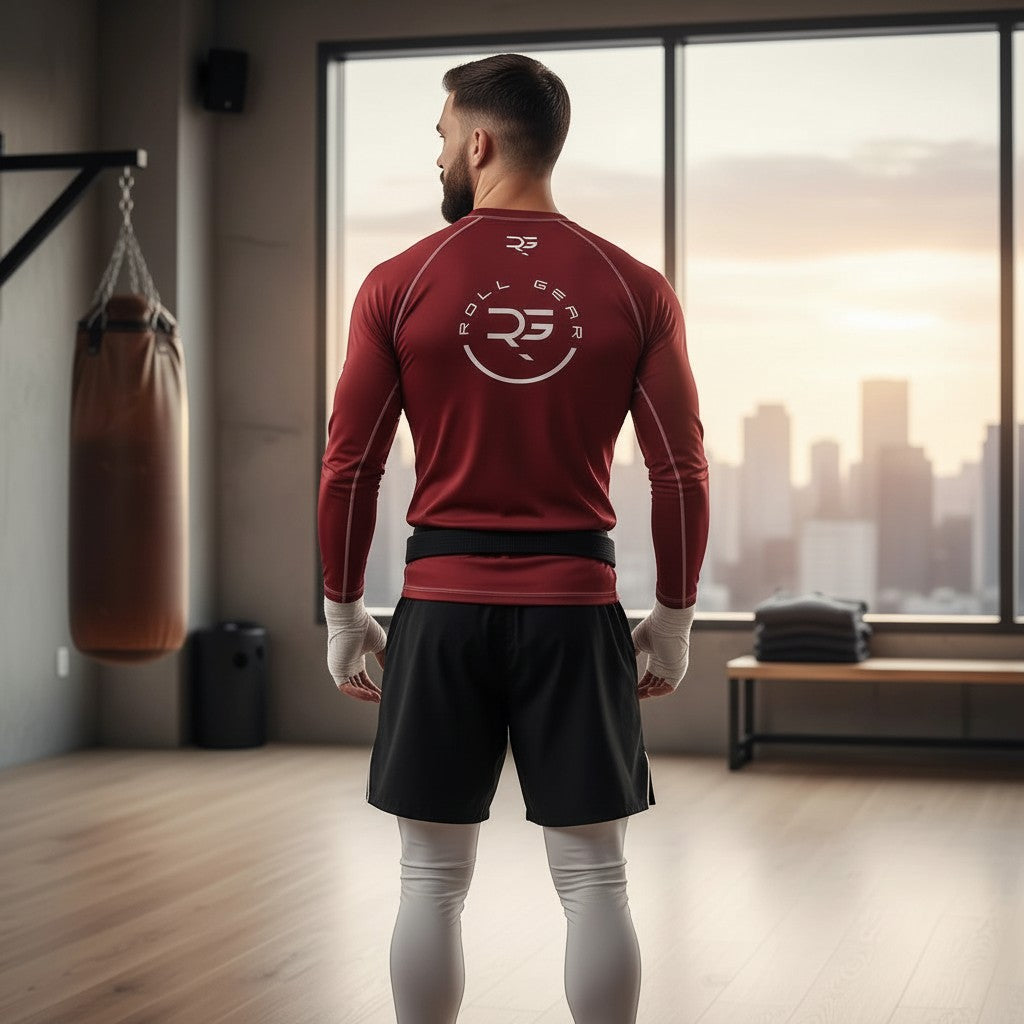 Roll Gear men's deep red long sleeve rash guard with white logo on chest. Athletic fit, moisture-wicking fabric.