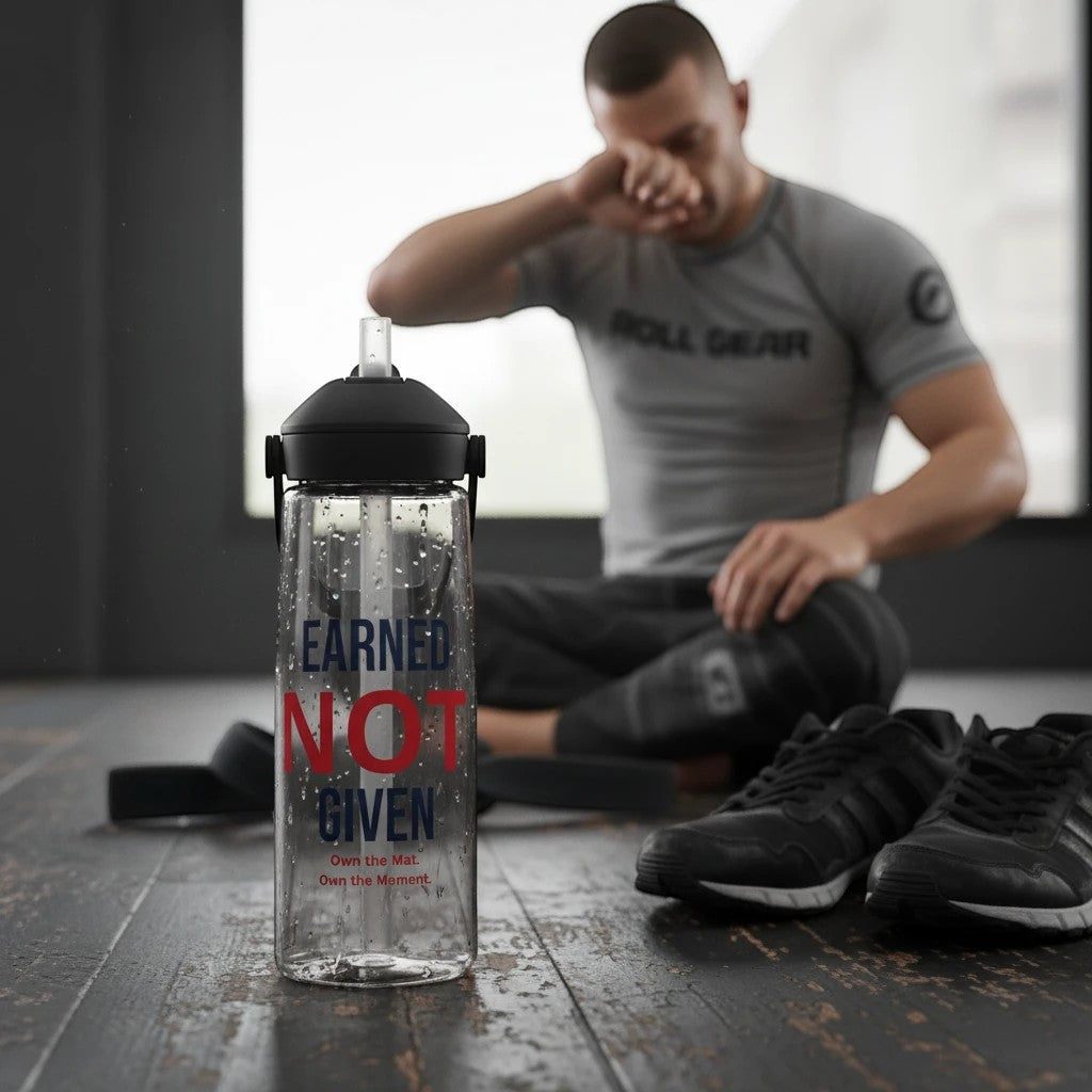 Roll Gear Earned Not Given 25 oz clear water bottle with black lid and straw. Motivational text "Earned Not Given" in blue and red.