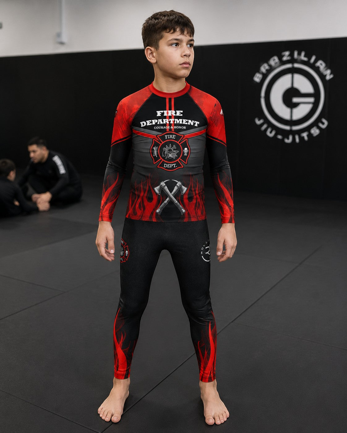 Roll Gear black compression spats with red flames for kids, featuring fire department graphics and four-way stretch fabric.
