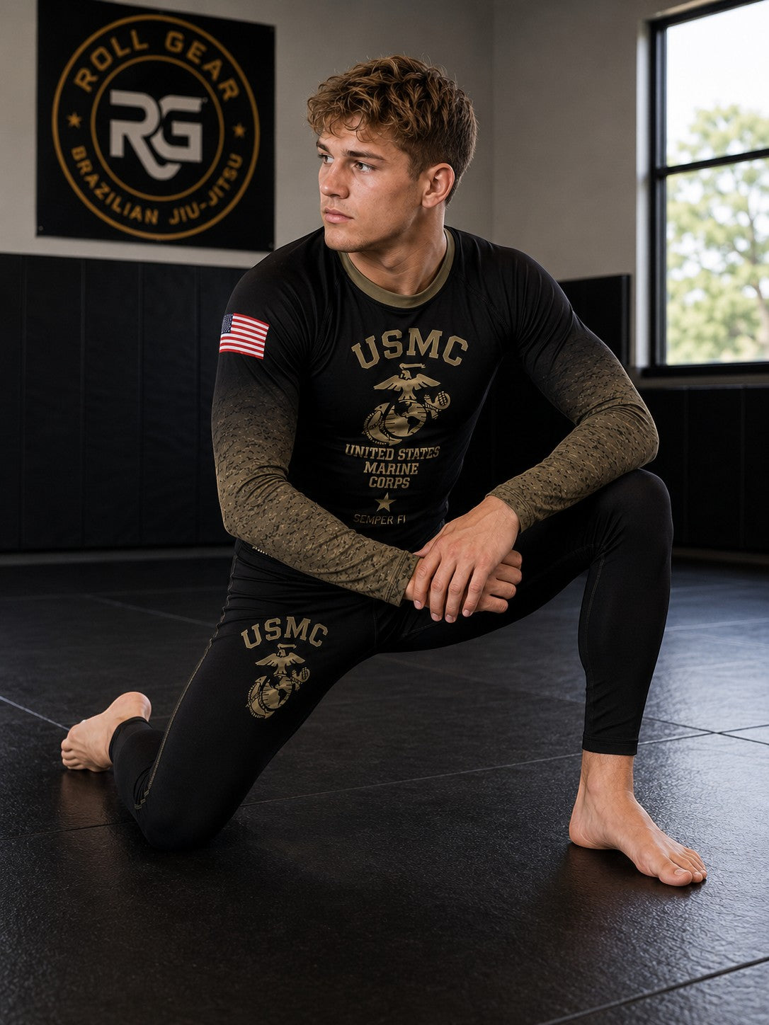 Roll Gear Kids Marines “Gold” military rash guard in black with faded gold sleeves and USMC emblem. Compression fit, long sleeve.