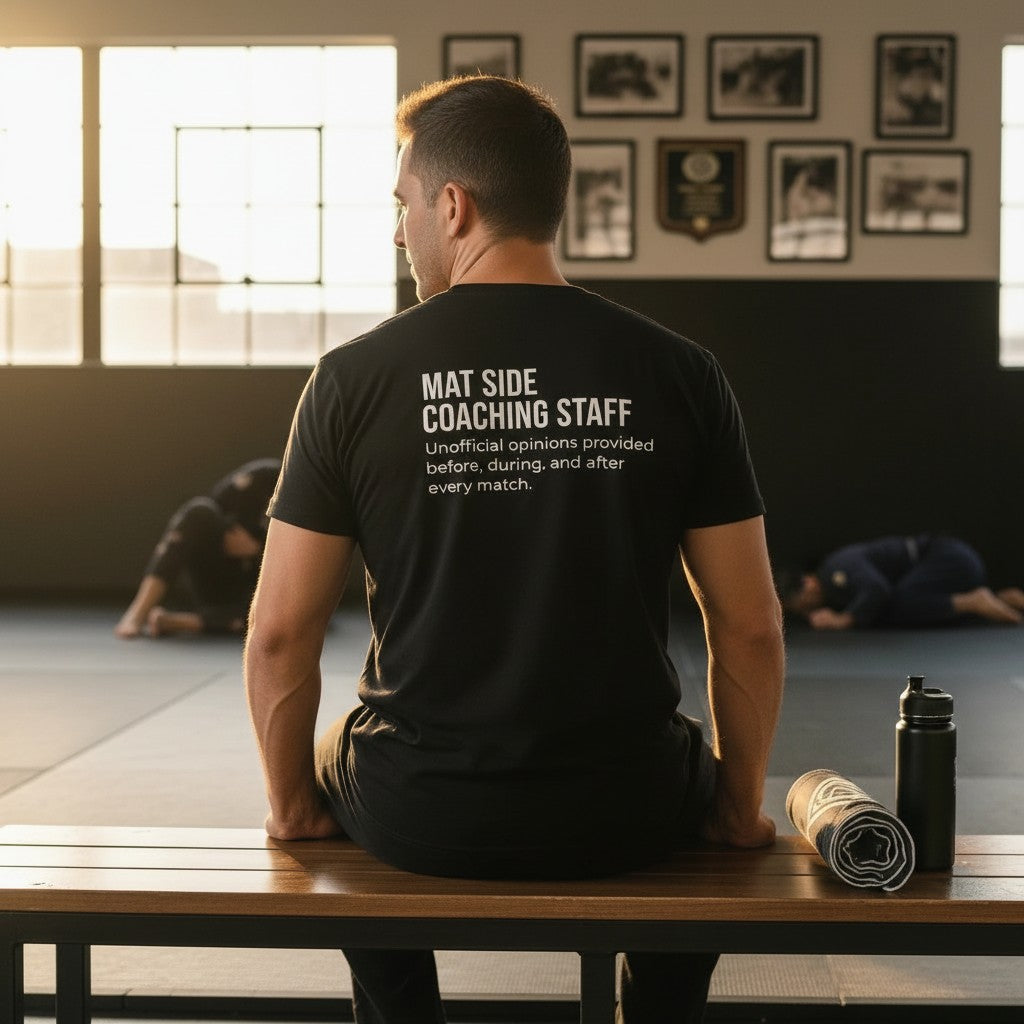 Roll Gear black 100% cotton heavyweight t-shirt with "Mat Side Coaching Staff" graphic on front and back.