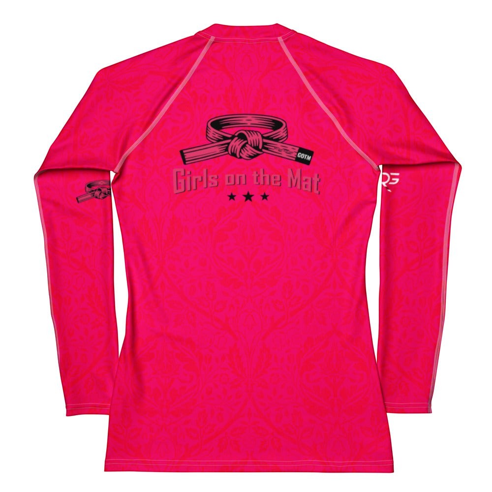 Roll Gear women's long sleeve rash guard in bright pink with "Girls on the Mat" graphic and martial arts belt detail.