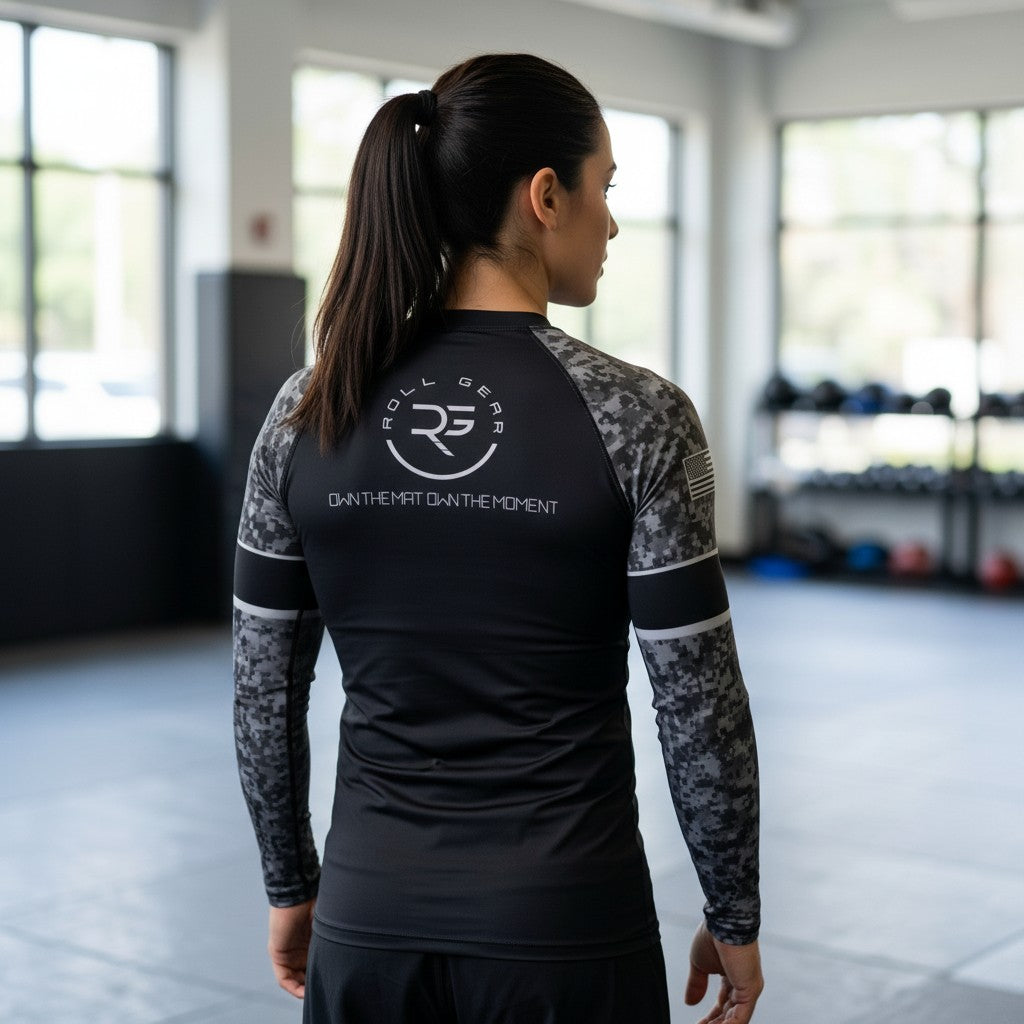 Roll Gear Women’s SWAT Edition long sleeve rash guard in black with urban camo sleeves and tactical graphics.
