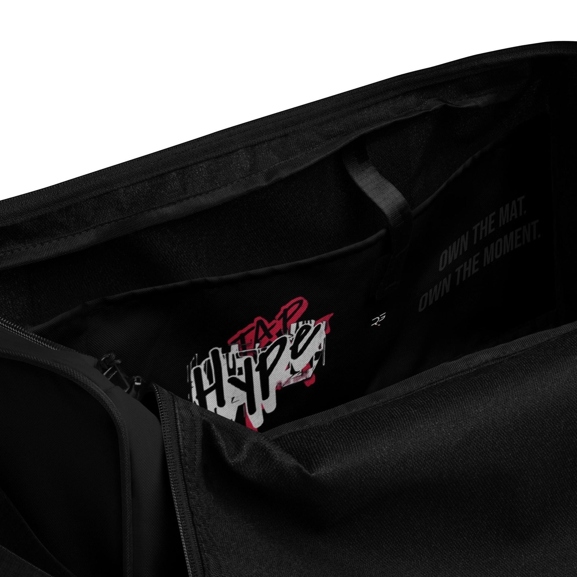 Black polyester Tap Hype training duffel bag by Roll Gear LLC with bold graphic detail and motivational text.
