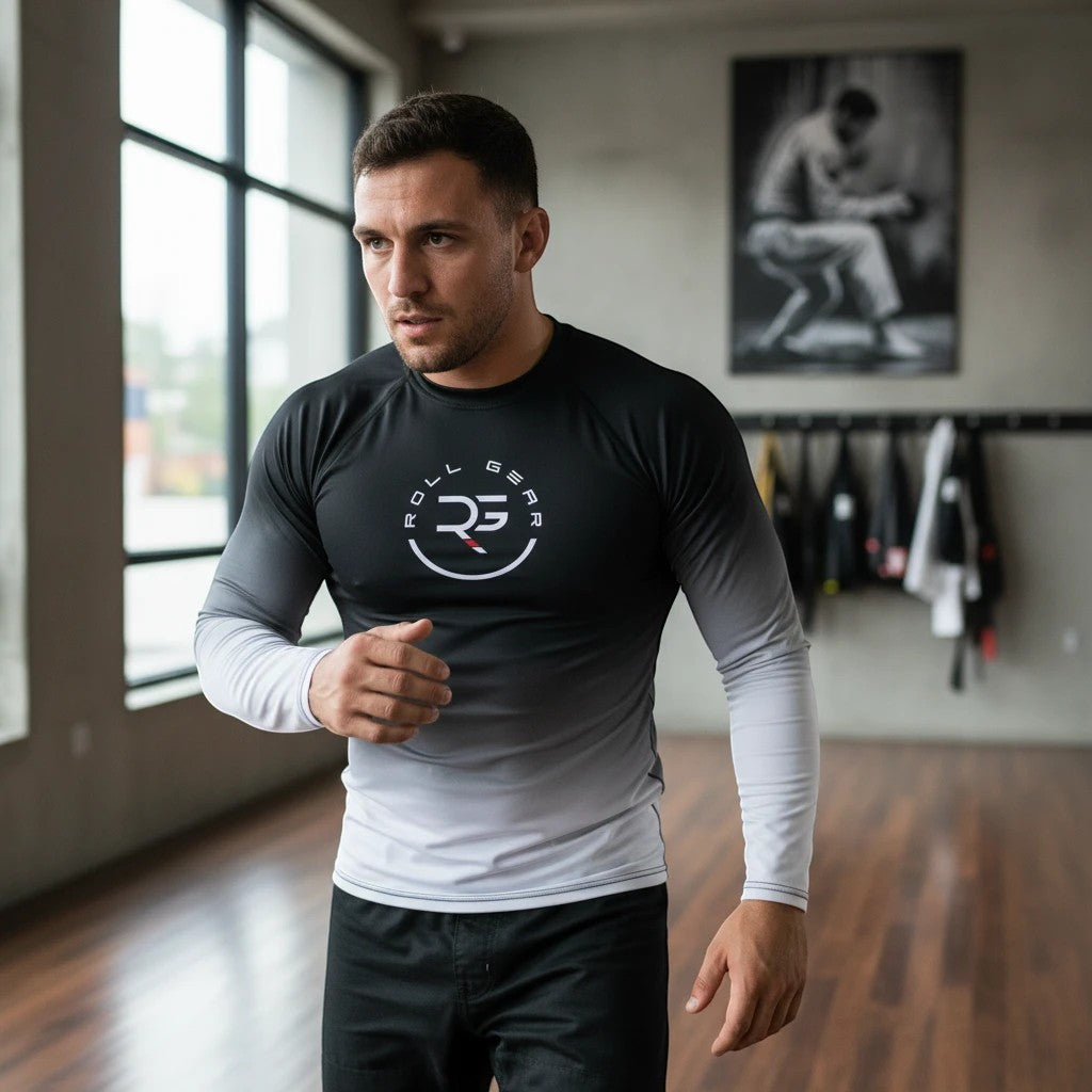 Roll Gear men's long sleeve rash guard in white and black fade. Moisture-wicking performance fabric with flatlock seams.