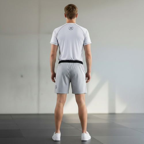 Roll Gear adult/unisex white short-sleeve performance rash guard with grey stitching and logo on back.