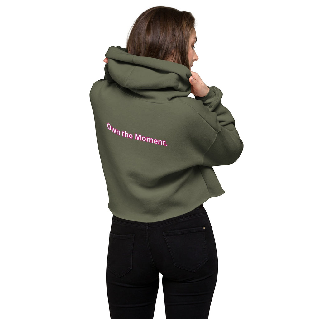 Roll Gear women's olive green cropped hoodie with pink "Own the Moment." text on back. Casual wear.