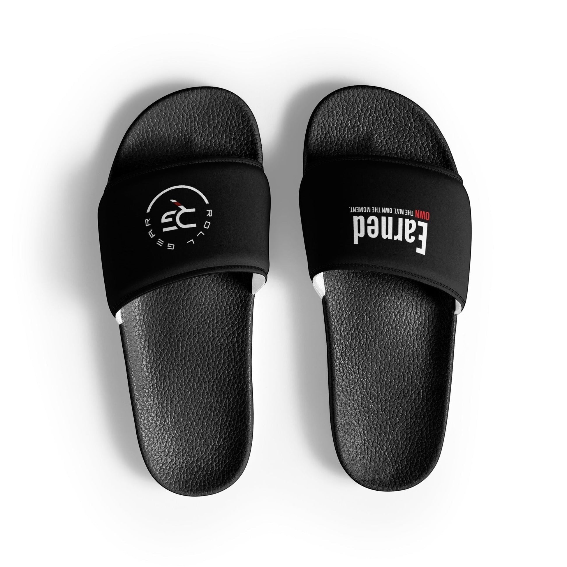 Roll Gear black women's slides with cushioned footbed and slip-on design. Features 'Earned' text and brand logo.