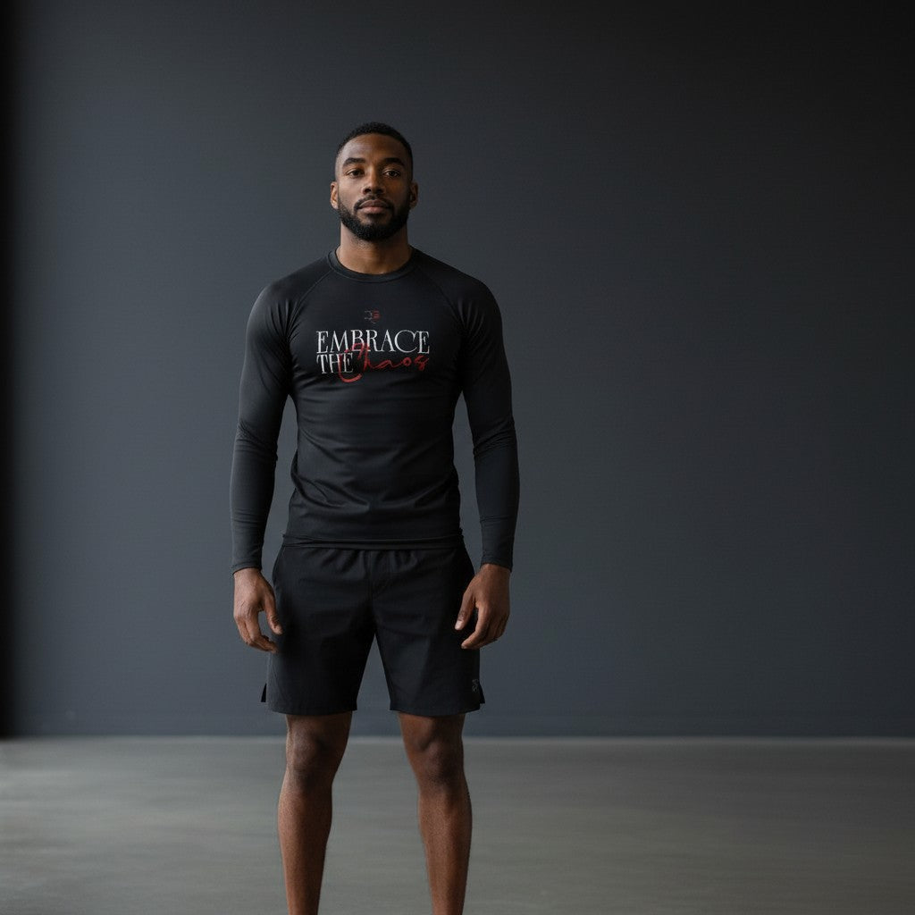 Roll Gear black long sleeve performance rash guard with "Embrace the Chaos" graphic and red accents.