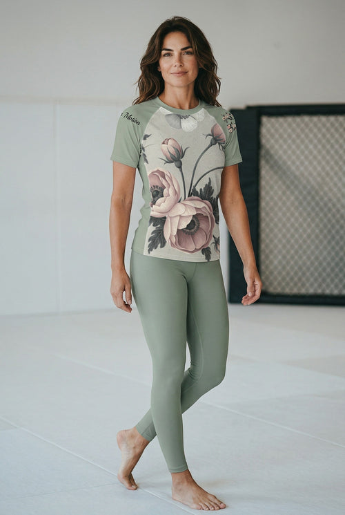 Roll Gear Always Blooming rash guard in sage green with floral print, short sleeves, athletic fit for women.