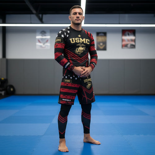 Roll Gear LLC USMC grappling shorts in black and red with USMC and Eagle Globe and Anchor graphics. Long cut with split leg for mobility.