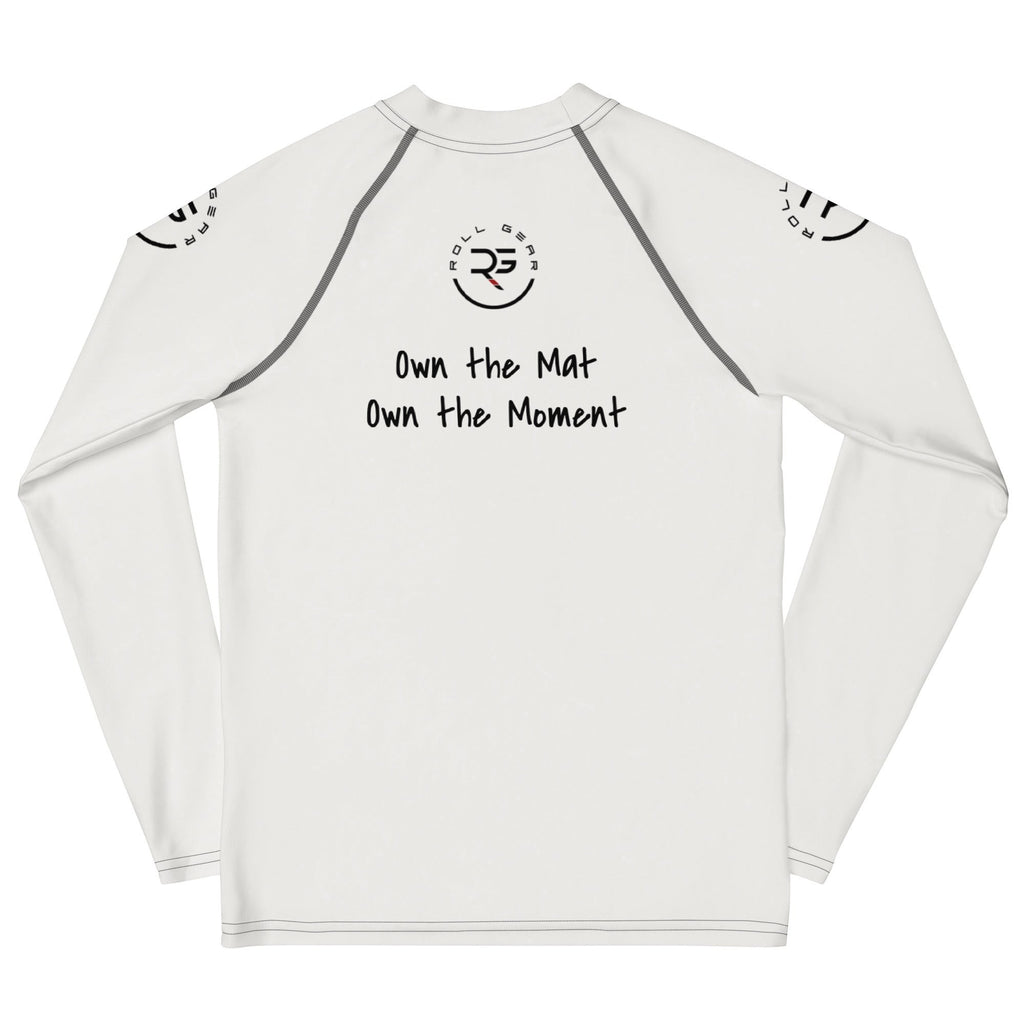 Roll Gear white long sleeve performance rash guard with graphic text "Own the Mat Own the Moment" and logo.